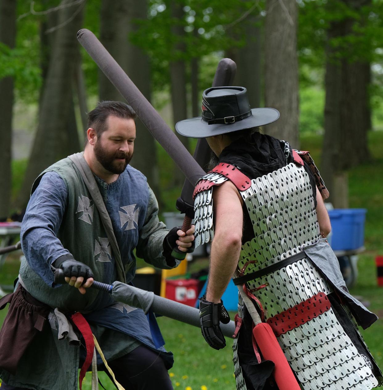 Members of the Ashen Hills community clash with foam weapons and engage in a role-playing fantasy game called Amtgard every Sunday in Partriarche Park in East Lansing Sunday, May 15, 2022. The community is about 30 to 35 members strong and is open to newcomers who want to try it out. All of the costumes and weapons are handmade and are carefully inspected for safety before each match.