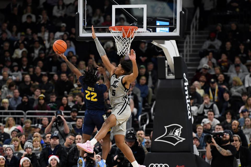 Marquette guard Sean Jones, who got only five minutes of playing time in the loss to Providence, tries to sneak a shot around the Friars' Ed Croswell.