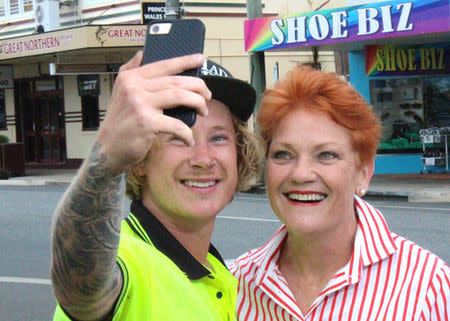 FILE PHOTO: Australian senator Pauline Hanson laughs as she has a photograph taken with local resident Brodie Tophan in the main street of the northern Australian town of Proserpine in Queensland, Australia, November 9, 2017. REUTERS/Jonathan Barrett/File Photo