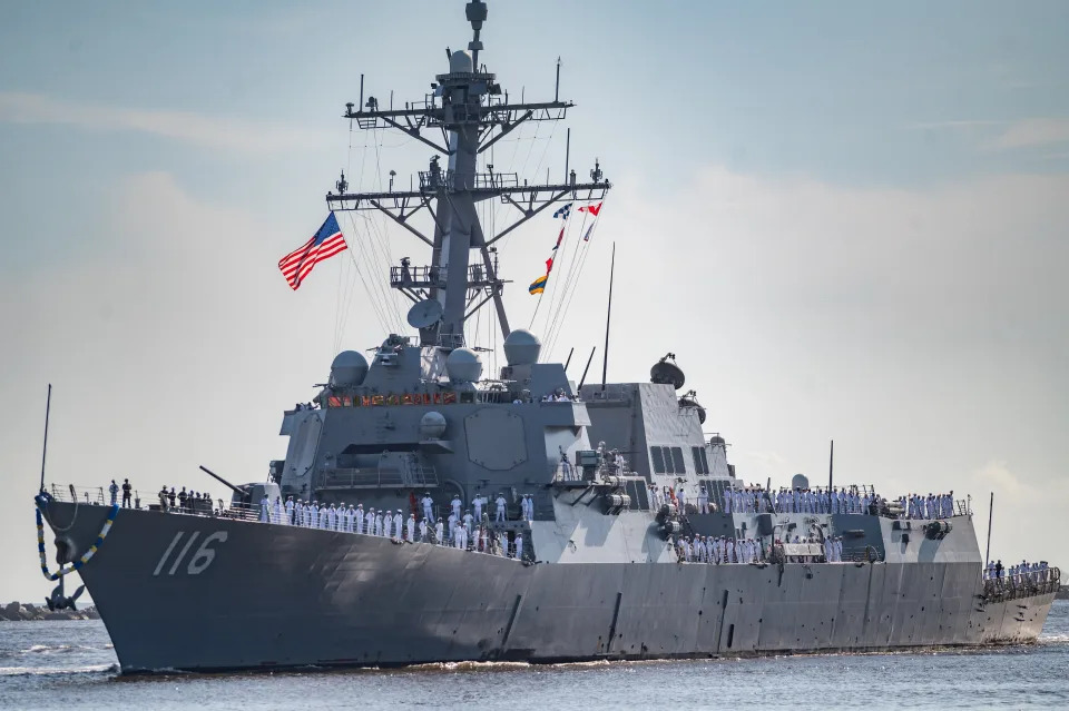 Crew members of The USS Thomas Hudner (DDG 116) line the deck of the destroyer class ship as it returned to its homeport of Naval Station Mayport in July 2021 after it's maiden voyage deployed for six months in support of operations in the 5th and 6th Fleet areas of responsibility.