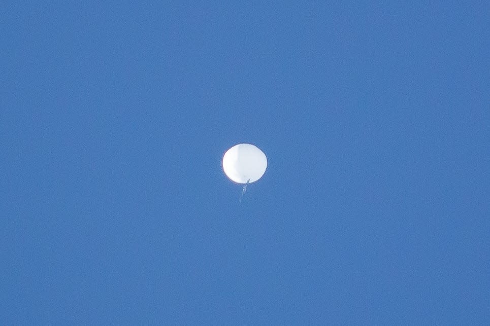 A balloon the U.S. Department of Defense is calling a "high-altitude surveillance balloon" drifts over Western North Carolina in this photo captured by UNC Asheville Meteorology major Evan Fisher and posted to his @EFisherWX Twitter page. The photo was taken in the Fairview area.