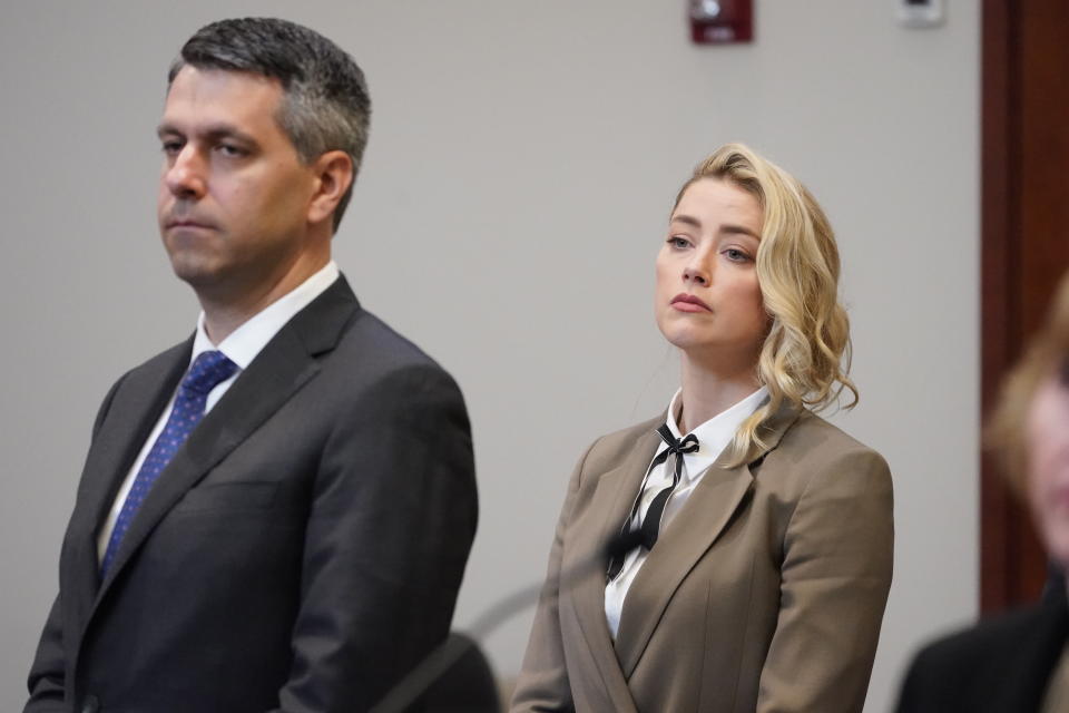 Actor Amber Heard watches as the jury arrives into the courtroom after a break at the Fairfax County Circuit Courthouse in Fairfax, Va., Monday, May 23, 2022. Actor Johnny Depp sued his ex-wife Amber Heard for libel in Fairfax County Circuit Court after she wrote an op-ed piece in The Washington Post in 2018 referring to herself as a "public figure representing domestic abuse." (AP Photo/Steve Helber, Pool)