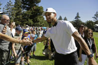 Stephen Curry greets fans while walking to the seventh tee of the Silverado Resort North Course during the pro-am event of the Safeway Open PGA golf tournament Wednesday, Sept. 25, 2019, in Napa, Calif. (AP Photo/Eric Risberg)