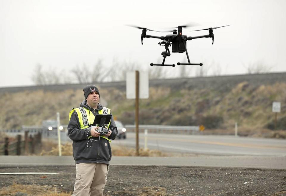 Detective Ryan Sauve with the Washington State Patrol launches a drone Monday to photograph Highway 397 at South Yew Street in Kennewick where a pickup and car collided Sunday, hurting four people. Fernando Hernandez, 54, crossed the center line on Chemical Drive in his pickup at 11:47 p.m. and hit a Corolla driven by David Hoopes, 43, said the WSP. Both Kennewick drivers and Hoopes female passengers, ages 5 and 74, were taken to Trios Southridge Hospital. Their conditions were not available Monday.