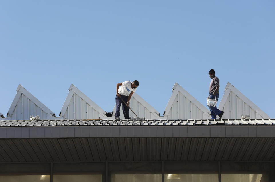 In this photo taken Tuesday, May 19, 2020, a field hospital under construction at a sports complex in Khayelitsha in Cape Town South Africa. With dramatically increased community transmission, Cape Town has become the center of the COVID-19 outbreak in South Africa and the entire continent. (AP Photo/Nardus Engelbrecht)