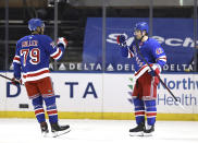 New York Rangers' K'Andre Miller (79) congratulates teammate Brendan Smith (42) after Smith scored a goal in the first period against the Philadelphia Flyers during an NHL hockey game Thursday, April 22, 2021, in New York. (Elsa/Pool Photo via AP)