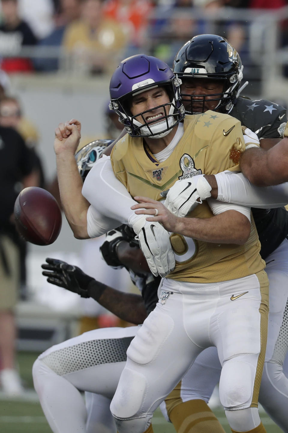 AFC defensive end Calais Campbell, of the Jacksonville Jaguars, (93) sacks NFC quarterback Kirk Cousins, of the Minnesota Vikings, and fumbles the ball, during the second half of the NFL Pro Bowl football game, Sunday, Jan. 26, 2020, in Orlando, Fla. (AP Photo/John Raoux)