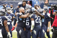 Tennessee Titans running back Derrick Henry (22) is mobbed by teammates after Henry scored the winning touchdown against the Houston Texans in overtime of an NFL football game Sunday, Oct. 18, 2020, in Nashville, Tenn. The Titans won 42-36. (AP Photo/Wade Payne)