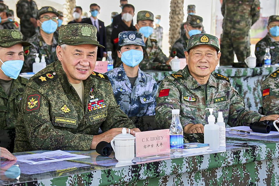 FILE - In this handout photo released by Russian Defense Ministry Press Service, Russian Defense Minister Sergei Shoigu and Chinese Defense Minister Wei Fenghe watch a joint military exercise by Russia and China held in the Ningxia Hui Autonomous Region in northwestern China, Aug. 13, 2021. Shoigu hailed joint war games with China this week as a sign of increasingly close ties and vowed to further expand military cooperation between the two countries. (Savitskiy Vadim/Russian Defense Ministry Press Service via AP, File)