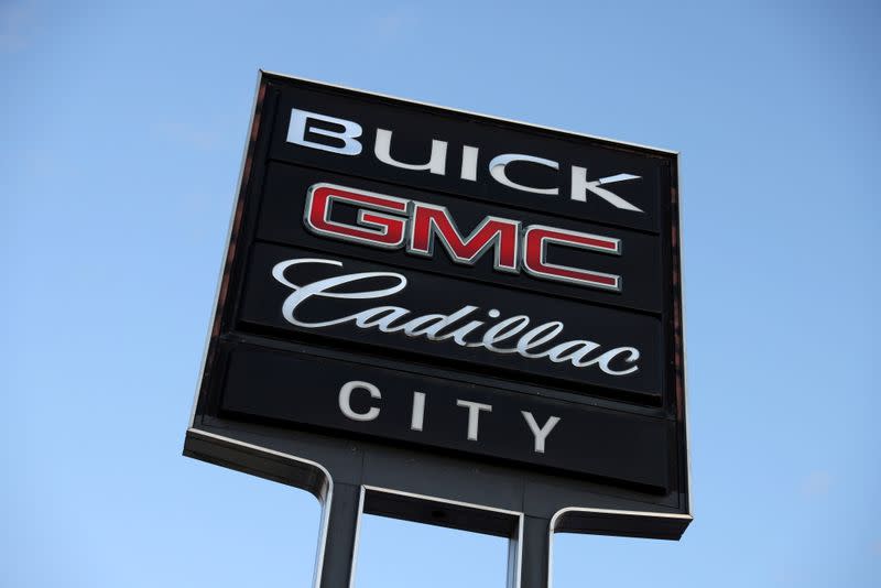 FILE PHOTO: Signs advertising Buick, GMC and Cadillac, automobile brands owned by General Motors Company, are seen at a car dealership in Queens, New York