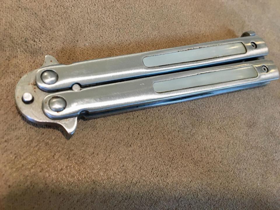 A balisong (butterfly knife) is a folding pocket knife with two handles that the blades rests in while closed. The two handles can be folded around to then expose the blade.