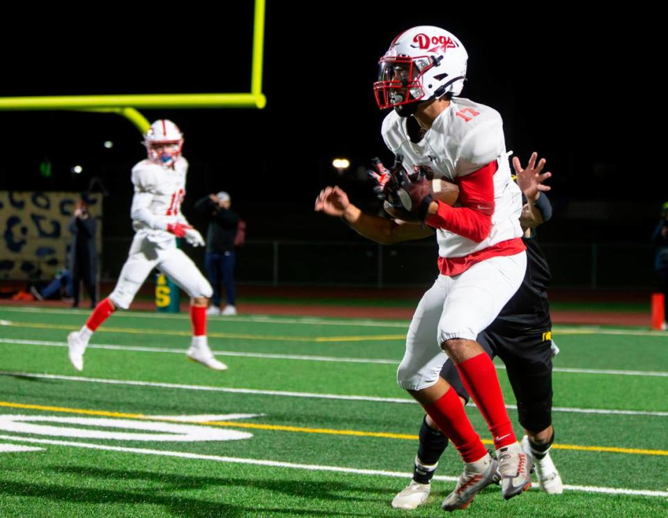 Ceres High’s Manuel Mendoza, 17, catches a first-down pass during a WAC game against Davis High on Friday Oct. 27, 2023.