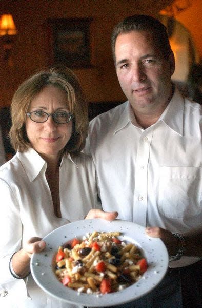 In a file photo, Donna and Steven Chioda serve up a “manzi dinner” at Chioda’s Trattoria. The Franklin Street restaurant will close later this month.