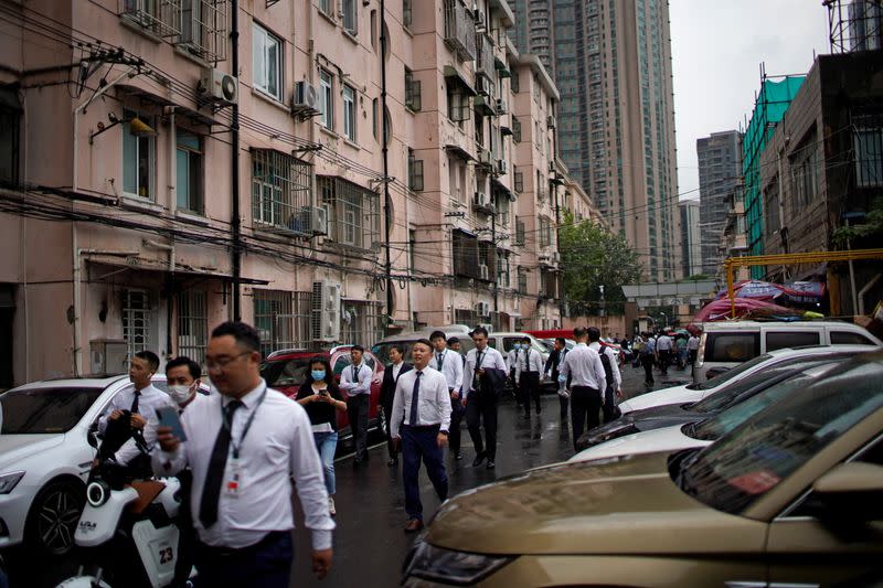 Security guards walk along at financial district of Lujiazui in Shanghai