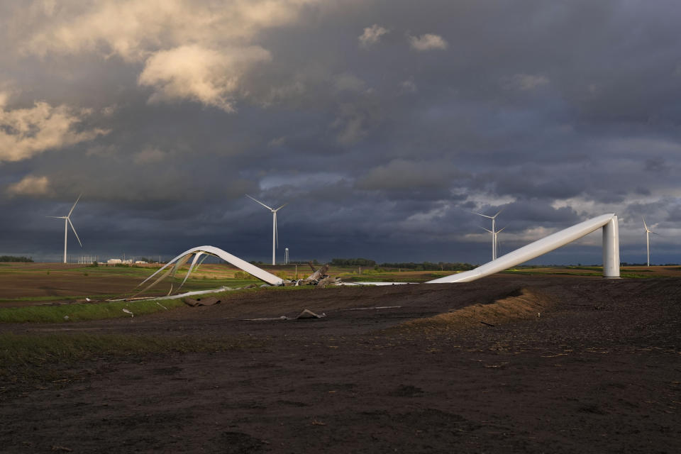 The remains of a tornado-damaged wind turbine touch the ground in a field, Tuesday, May 21, 2024, near Prescott, Iowa. (AP Photo/Charlie Neibergall)