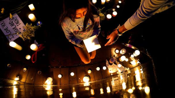 PHOTO: Community members light candles and leave messages at a memorial site near the parade route the day after a mass shooting at a Fourth of July parade in the Chicago suburb of Highland Park, Ill., July 5, 2022. (Cheney Orr/Reuters)