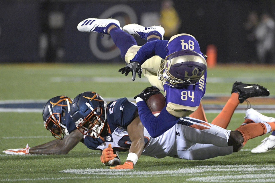 Atlanta Legends receiver Bug Howard (84) is tackled by Orlando Apollos safety Will Hill and defensive back Keith Reaser (29) during an AAF game. (AP)