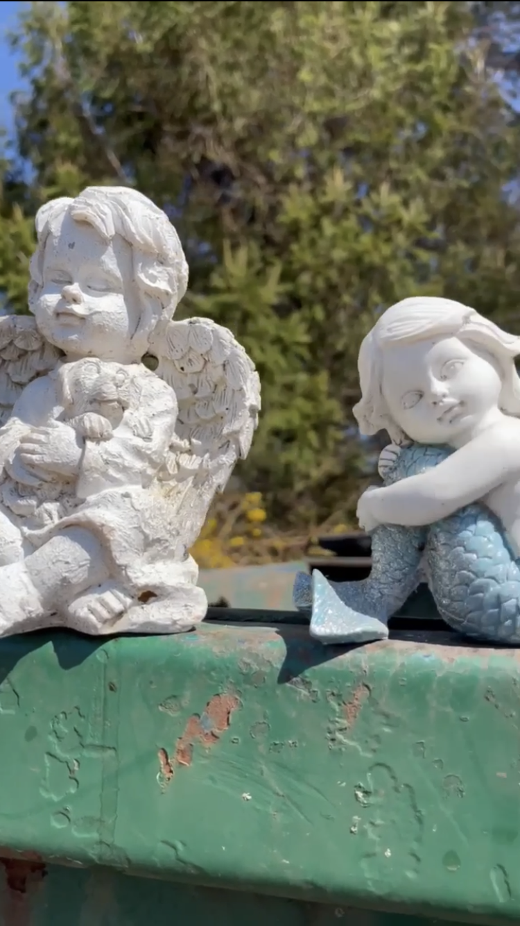 Two discarded decorations at Cedar Hill Cemetery sitting atop a dumpster at the cemetery, according to cemetery critics.
