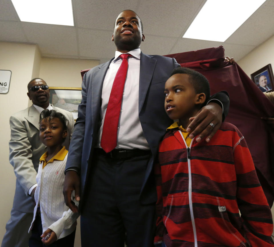 Newark mayoral candidate Shavar Jeffries, center, stands with his children, Naomi Jeffries, 7, left, and Kaleb Jeffries, 9, after casting his vote, Tuesday, May 13, 2014, in Newark, N.J. Tuesday's election will decide whether Jeffries, a former state assistant attorney general, or his opponent, City Councilman Ras Baraka, will take over the seat Cory Booker occupied from 2006 until October 2013, when he won a special election to succeed U.S. Sen. Frank Lautenberg, who died in office. (AP Photo)
