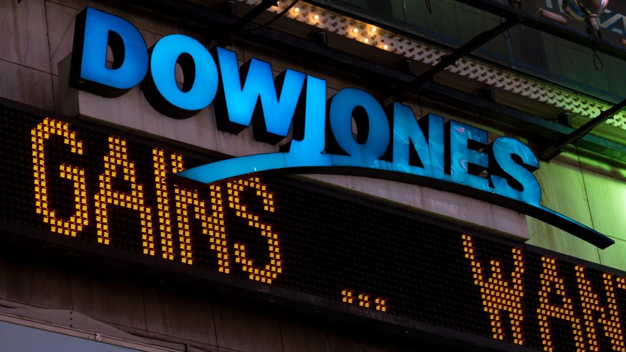 New York, USA - July 29, 2016: The illuminated Dow Jones sign in times square late in the night as the latest news streams on the led board.