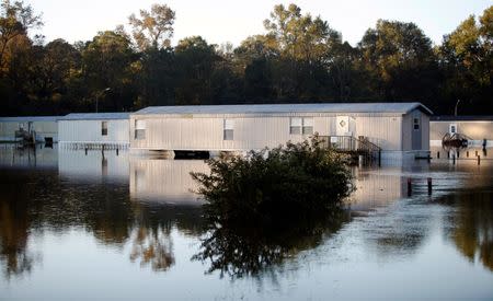 Mobile homes are reflected in the flood waters after Hurricane Matthew caused severe flooding in Goldsboro, North Carolina, U.S. October 13, 2016. REUTERS/Randall Hill