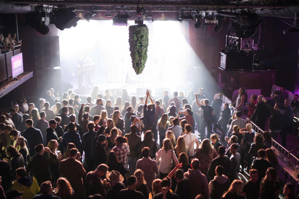 A depiction of a cannabis bud hangs from the ceiling as a band plays at Leafly’s countdown party in Toronto, Tuesday, Oct. 16, 2018, as they prepare to mark the legalization of Cannabis across Canada. (Chris Young/The Canadian Press via AP)