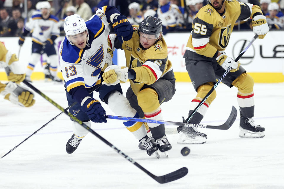 St. Louis Blues right wing Alexey Toropchenko (13) and Vegas Golden Knights defenseman Kaedan Korczak (6) collide during the first period of an NHL hockey game Monday, Dec. 4, 2023, in Las Vegas. (AP Photo/Ian Maule)