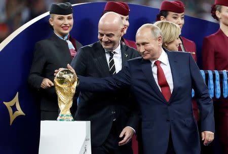 Soccer Football - World Cup - Final - France v Croatia - Luzhniki Stadium, Moscow, Russia - July 15, 2018 FIFA president Gianni Infantino and President of Russia Vladimir Putin with the World Cup trophy before the medals ceremony REUTERS/Damir Sagolj