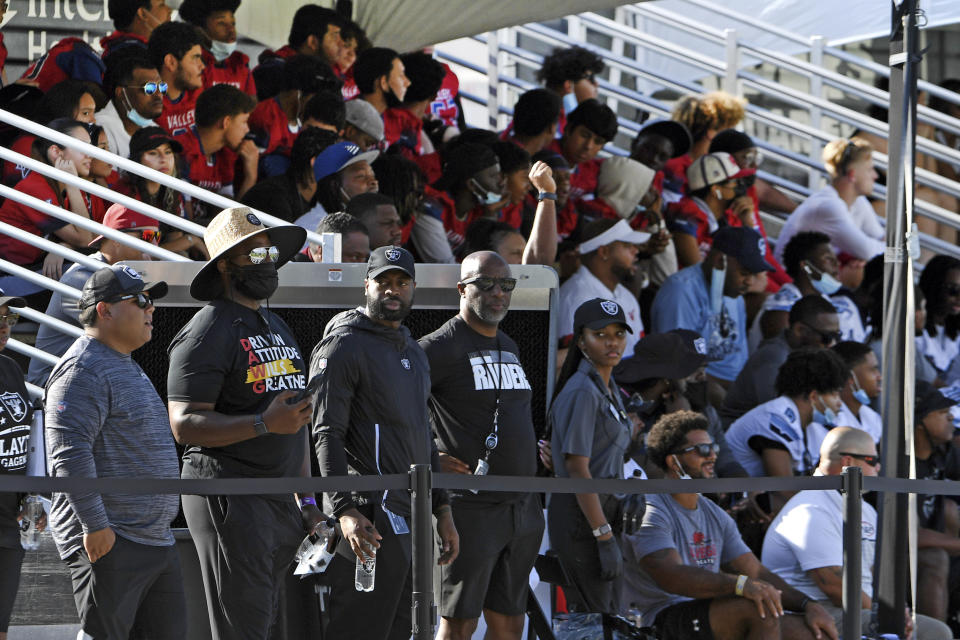 Las Vegas Raiders fans watch the team during an NFL football practice Saturday, July 31, 2021, in Henderson, Nev. (AP Photo/David Becker)