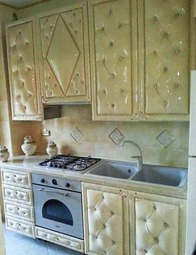 a kitchen with white upholstered cabinets