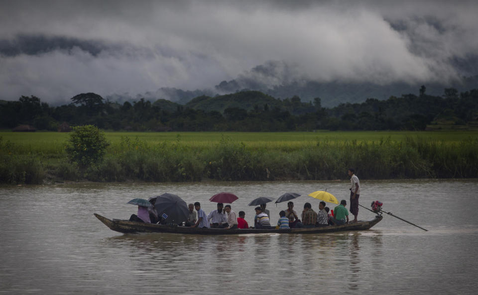 In this Sept. 16, 2013 photo, villagers travel in a river close to Buthidaung in Rakhine state, Myanmar. After closing its doors to the West for half a century, Myanmar has reopened, inviting all to come and discover its treasures, ancient palaces of kings long gone, legends and mysteries told in stone. With ill-equipped roads and railways, there is no better way to explore than by river. Public ferries crisscross through glistening green paddies; old teak fishing boats can be rented by the day. (AP Photo/Gemunu Amarasinghe)