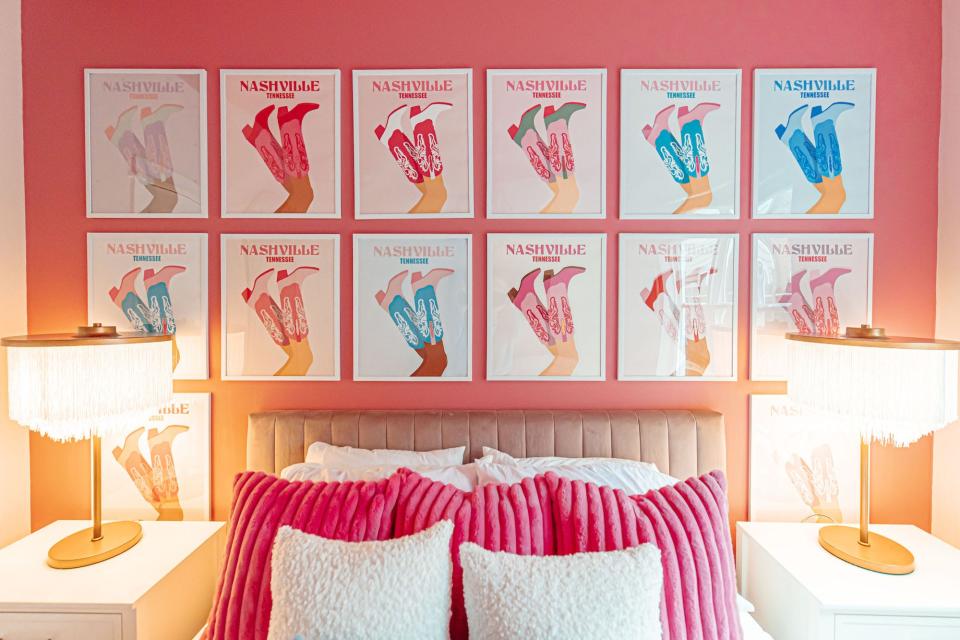 A bedroom with prints of colorful cowboy boots.