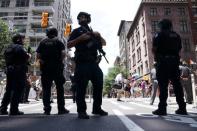 Police stand guard as participants take part in the LGBT Pride March in the Manhattan borough of New York City, U.S., June 25, 2017. REUTERS/Carlo Allegri