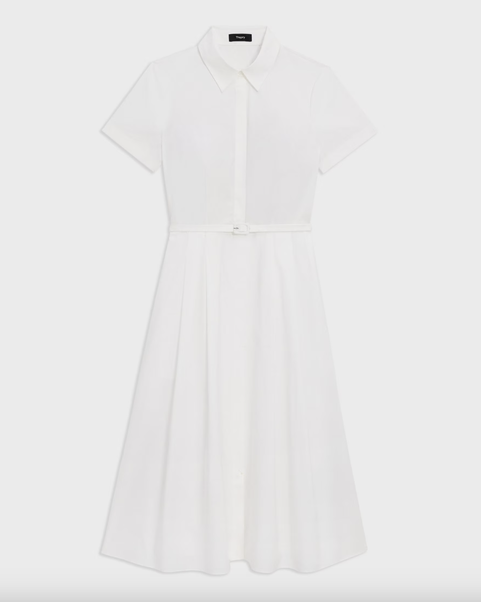 a white button down theory dress in front of a plain backdrop