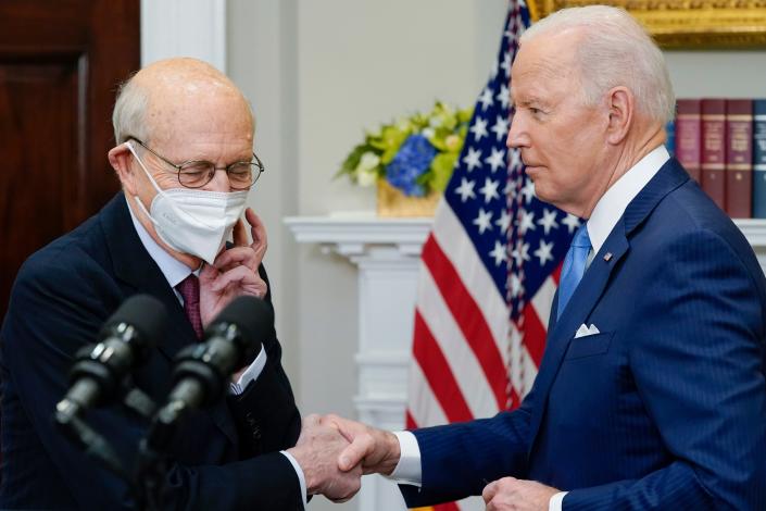 President Joe Biden shakes hands with Supreme Court Associate Justice Stephen Breyer as Breyer removes his face mask to speak about his retirement in the Roosevelt Room of the White House in Washington, Thursday, Jan. 27, 2022.