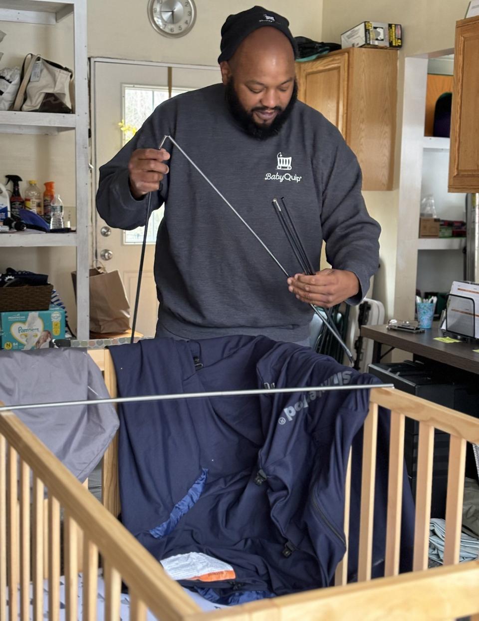 Al Harrison, of Wells, Maine, assembles a crib, one of many that BabyQuip rents out to its clients who lodge locally when on vacation. Harrison delivers baby gear and other traveling essentials to clients staying at local hotels, inns, resorts, and elsewhere.