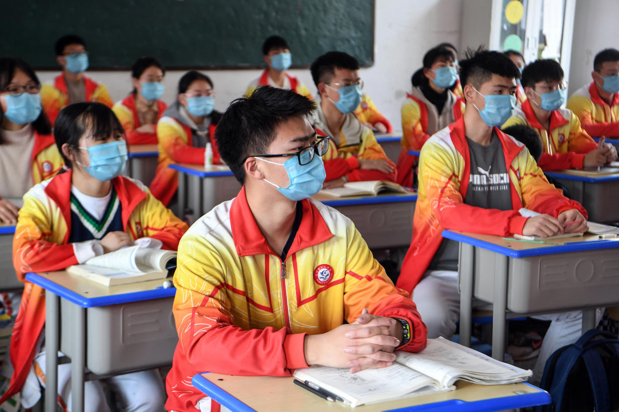 High school grade three students wearing face masks attend a class after the term opening was delayed due to the COVID-19 coronavirus outbreak, in Bozhou in China's eastern Anhui province on April 7, 2020. - China on April 7 reported no new coronavirus deaths for the first time since it started publishing figures in January, the National Health Commission said. (Photo by STR / AFP) / China OUT (Photo by STR/AFP via Getty Images)