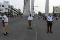 Traffic police personnel stand guard on a road junction during a one-day Janata (civil) curfew imposed amid concerns over the spread of the COVID-19 novel coronavirus, in Secunderabad, the twin city of Hyderabad, on March 22, 2020. (Photo by NOAH SEELAM / AFP) (Photo by NOAH SEELAM/AFP via Getty Images)