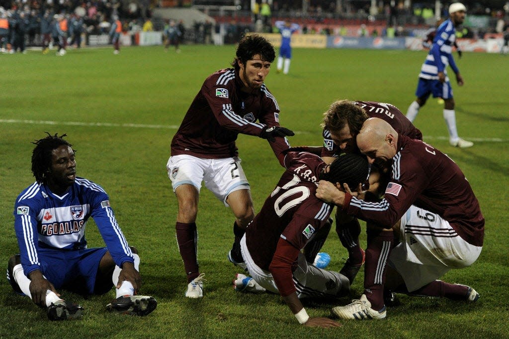 Macoumba Kandji (10) is congratulated after the Colorado Rapids scored the go-ahead goal against FC Dallas in the 2010 MLS Cup.