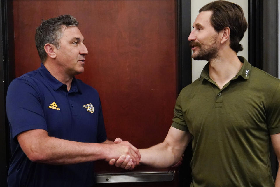 Nashville Predators head coach Andrew Brunette, left, shakes hands with left wing Filip Forsberg after a news conference introducing Brunette as the new head coach at the NHL hockey team's arena, Wednesday, May 31, 2023, in Nashville, Tenn. (AP Photo/George Walker IV)