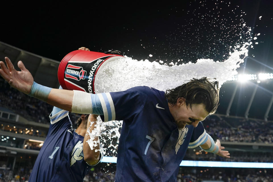 KANSAS CITY, MISSOURI - JUNE 07: Bobby Witt Jr.  #7 of the Kansas City Royals is doused with water by MJ Melendez #1 of the Kansas City Royals after a 10-9 win over the Seattle Mariners at Kauffman Stadium on June 7, 2024 in Kansas City, Missouri.  (Photo by Ed Zurga/Getty Images)