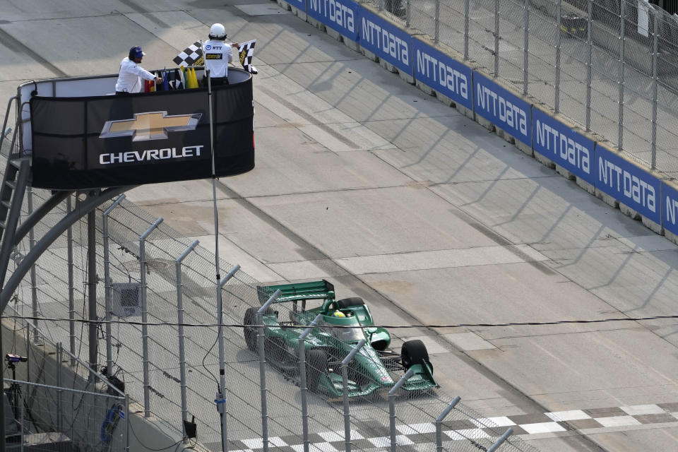 Alex Palou takes the checkered flag at the IndyCar Detroit Grand Prix auto race, Sunday, June 4, 2023, in Detroit. (AP Photo/Carlos Osorio)