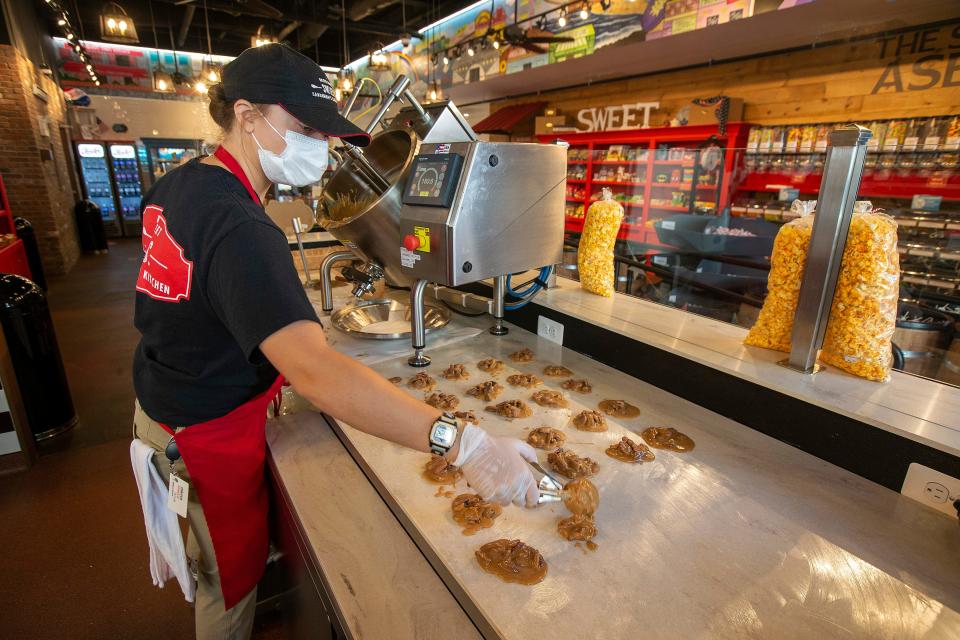 Taylor Mennie, daughter of River Street Sweets and Savannah's Candy Kitchen owner Robin Mennie, makes pralines at the Asbury Park sweet shop.