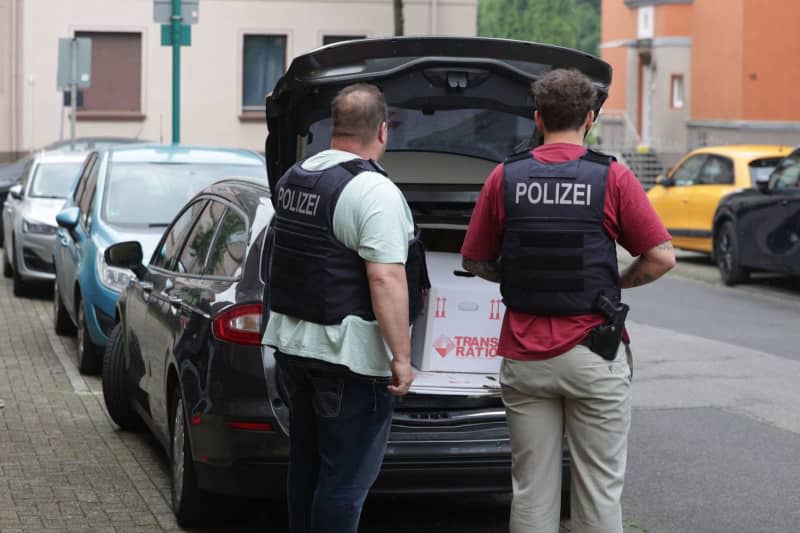 German police officers load a box of seized items into a car, following a search of an apartment, as part of action taken against a group allegedly supporting Hamas. The raid comes as the Ministry of the Interior in North Rhine-Westphalia on 16 May also banned the Palestine Solidarity Duisburg. David Young/dpa