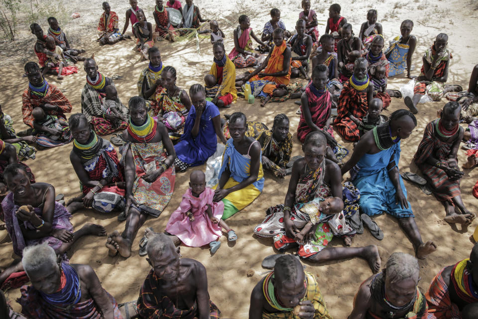 Villagers gather during a visit by United Nations Under-Secretary-General for Humanitarian Affairs Martin Griffiths, in the village of Lomoputh in northern Kenya Thursday, May 12, 2022. Griffiths visited the area on Thursday to see the effects of the drought which the U.N. says is a severe climate-induced humanitarian emergency in the Horn of Africa. (AP Photo/Brian Inganga)