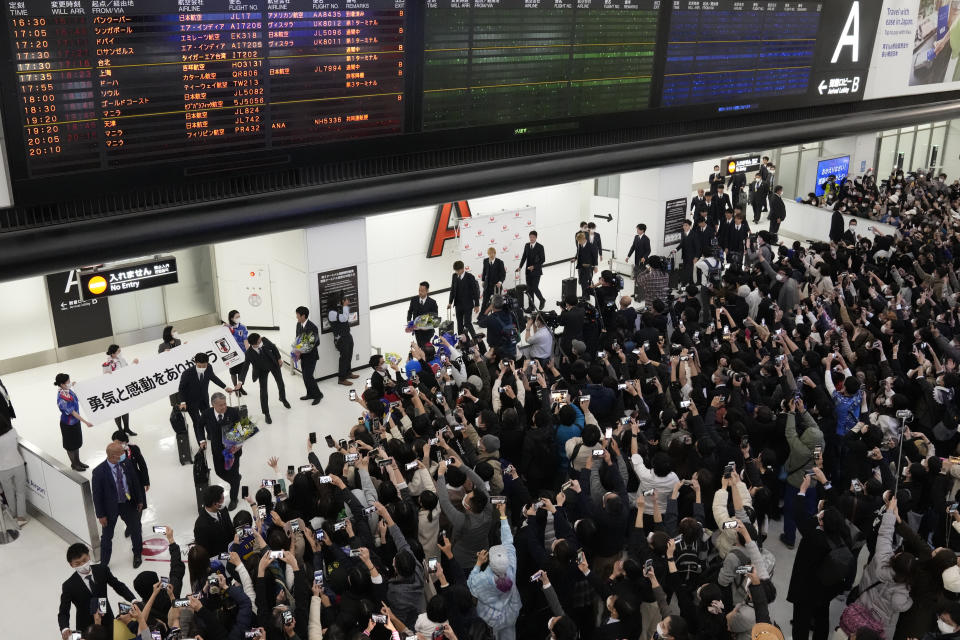 Supporters welcome home Japanese national soccer team from the World Cup in Qatar, at Narita International Airport in Narita, east of Tokyo, Wednesday, Dec. 7, 2022.(AP Photo/Shuji Kajiyama)