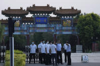 A member of security personnel gestures towards journalists outside the Tianjin Binhai No. 1 Hotel where U.S. and Chinese officials are expected to hold talks in Tianjin municipality in China on Sunday, July 25, 2021. Deputy Secretary of State Wendy Sherman travelled to China this weekend on a visit that comes as tensions between Washington and Beijing soar on multiple fronts, the State Department said Wednesday. (AP Photo/Ng Han Guan)