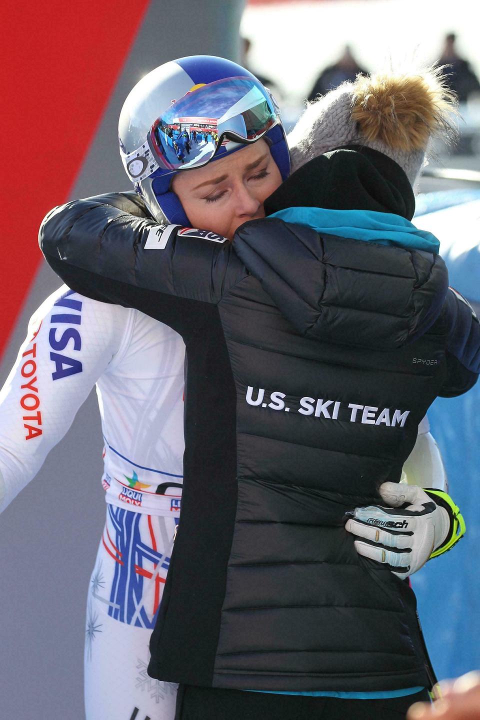 FILE - In this Sunday, Jan. 20, 2019 file photo, United States' Lindsey Vonn hugs a US team staffer in the finish area of an alpine ski, women's World Cup super-G in Cortina D'Ampezzo, Italy. It seemed like destiny played a role on Sunday when Mikaela Shiffrin won what could very well turn out to be Lindsey Vonn's last race. Vonn broke down emotionally after she failed to finish a World Cup super-G on knees so worn down that she describes them as "bone on bone." Shiffrin then came down nine racers later and won her first speed race at the premier stop on the women's circuit. (Andrea Solero/ANSA via AP)