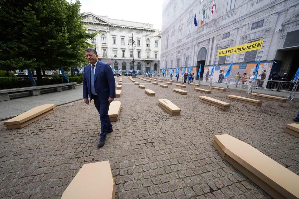 UIL trade union general secretary Pierpaolo Bombardieri walks through 172 coffins, as many as the number of deaths at work that Lombardy recorded in 2023 at the La Scala theatre during a flash mob organised by UIL trade union organization, in Milan, Italy, Friday, May 10, 2024. (AP Photo/Luca Bruno)