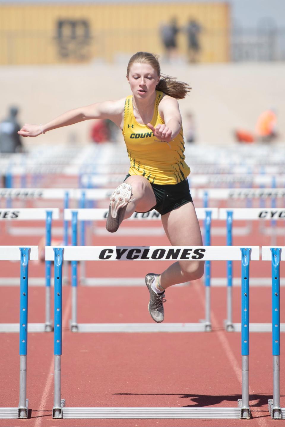 Pueblo County's Kyla Ruzich clears a hurdle during a meet at Pueblo West High School on Thursday, March 30, 2023.